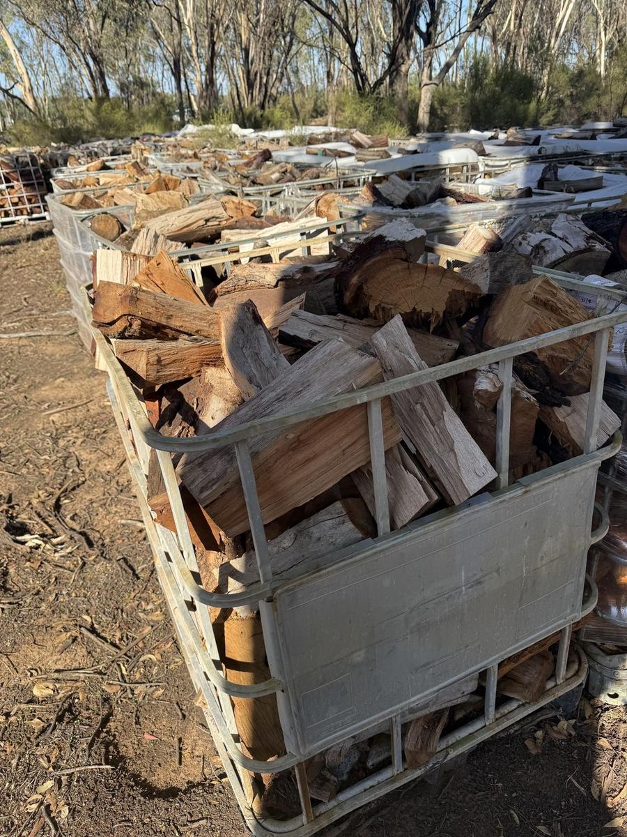 Cut firewood and timber stacked in a crate